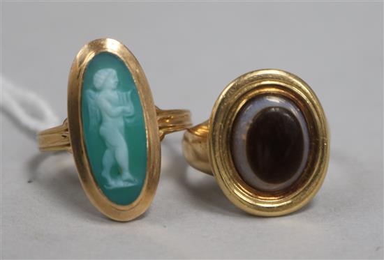 A 19th century Italian yellow metal cameo ring and and an onyx and yellow metal ring.